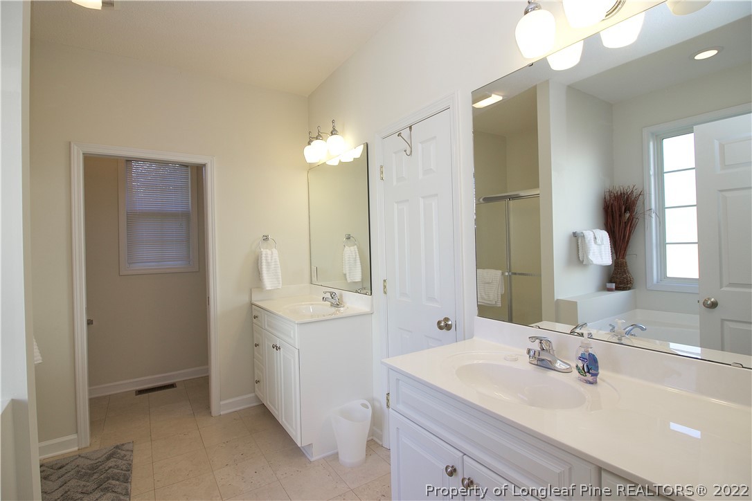 215 Kelly Road Pinehurst, NC 28374 - Photo 14 of 27 a bathroom with a sink and a mirror