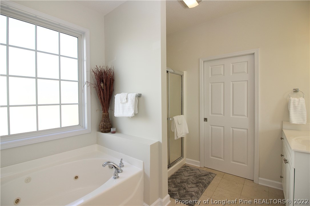 215 Kelly Road Pinehurst, NC 28374 - Photo 15 of 27 a bathroom with a bathtub and a shower