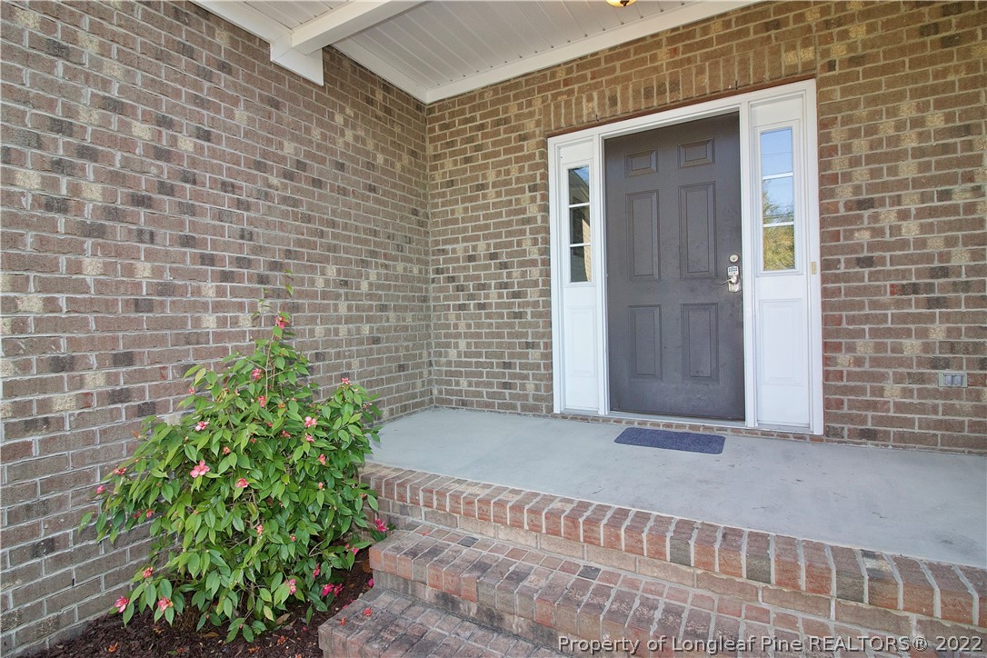 215 Kelly Road Pinehurst, NC 28374 - Photo 2 of 27 a view of a brick house with a yard