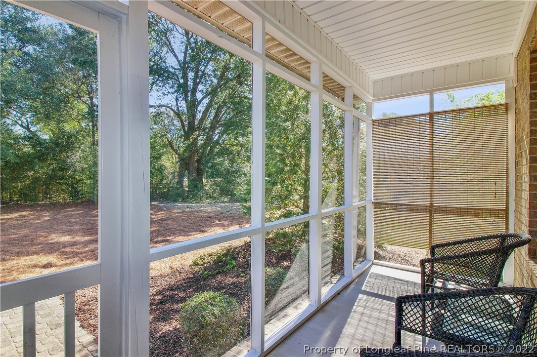 215 Kelly Road Pinehurst, NC 28374 - Photo 22 of 27 a view of a balcony with chair and wooden floor