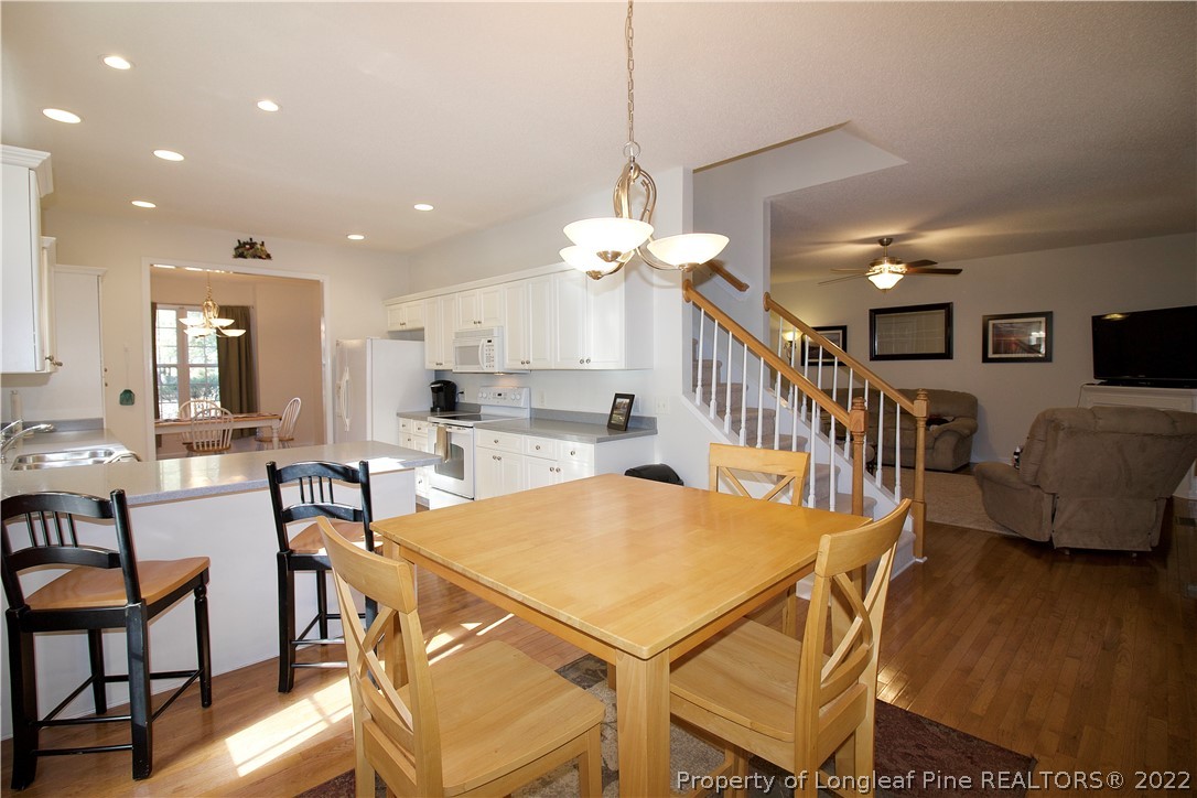 215 Kelly Road Pinehurst, NC 28374 - Photo 7 of 27 a dining room with furniture and wooden floor