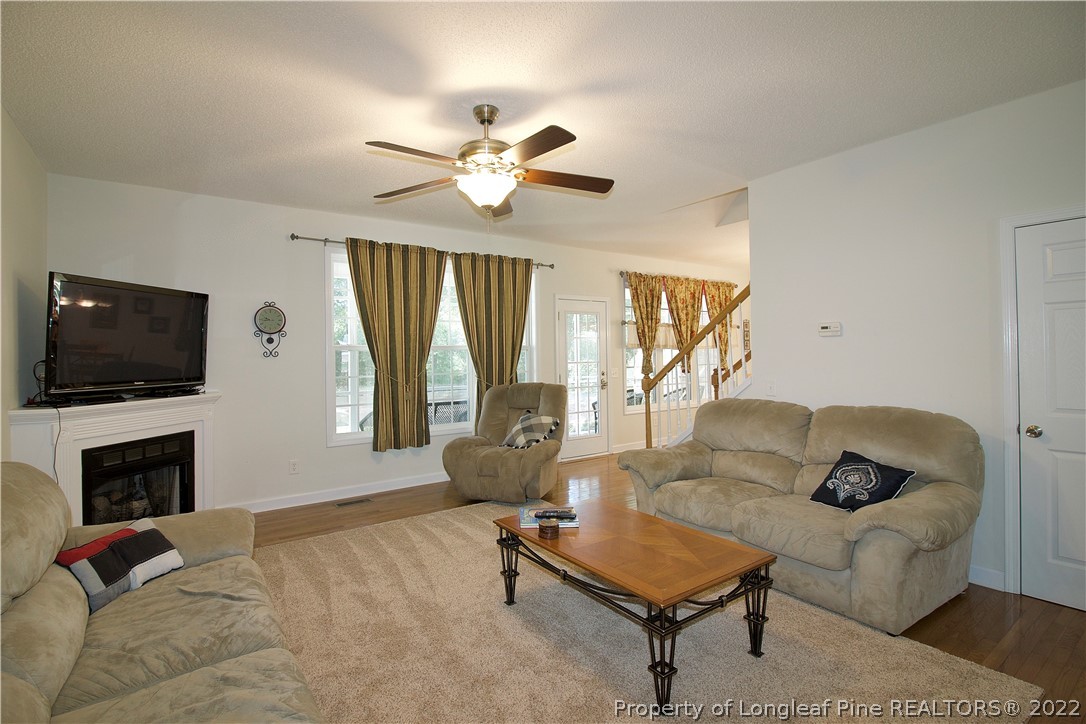 215 Kelly Road Pinehurst, NC 28374 - Photo 9 of 27 a living room with furniture and a flat screen tv