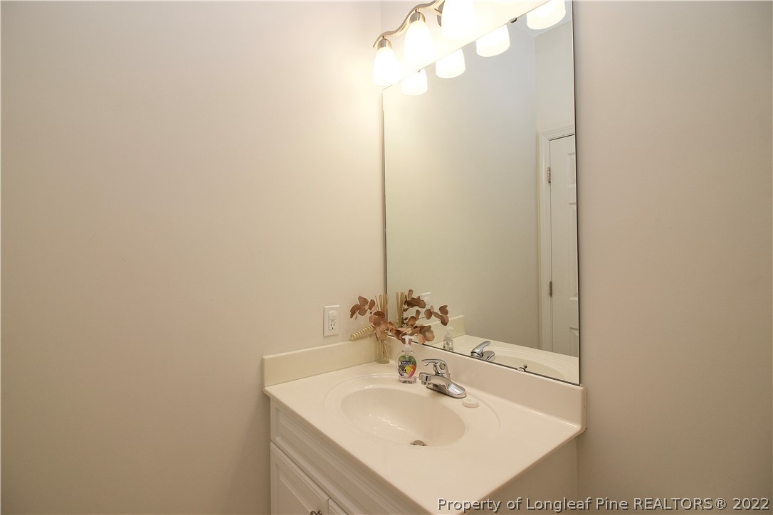 215 Kelly Road Pinehurst, NC 28374 - Photo 10 of 27 a bathroom with a sink and a mirror