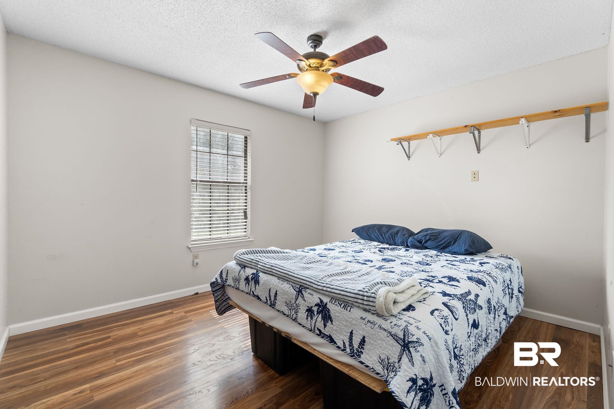 33135 Collier Road Lillian, AL 36549 - Photo 23 of 30 Bedroom featuring a textured ceiling, dark wood-style flooring, and a ceiling fan