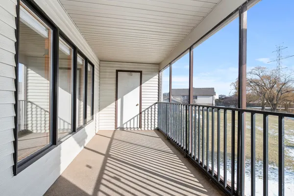 a view of balcony with wooden floor