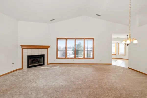 a view of an empty room with a fireplace