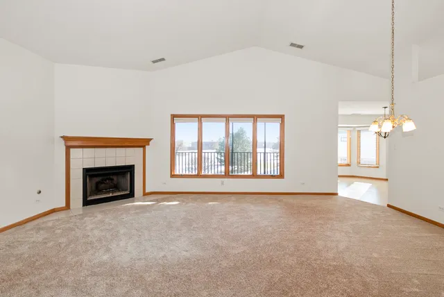 a view of an empty room with a fireplace