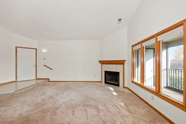 a view of empty room with a fireplace