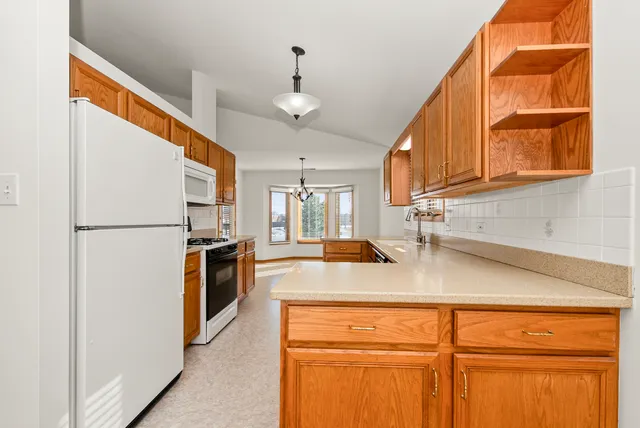 a kitchen with refrigerator cabinets and a sink
