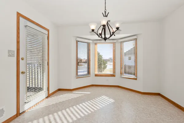 a view of a room with a window and chandelier