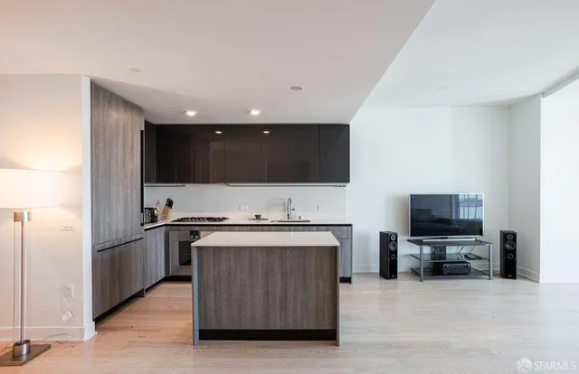 a kitchen with stainless steel appliances a stove a microwave a sink and a refrigerator