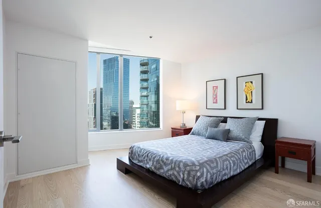 a bedroom with a large bed and a night stand