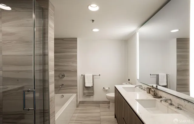 a bathroom with a double vanity sink a mirror and a shower