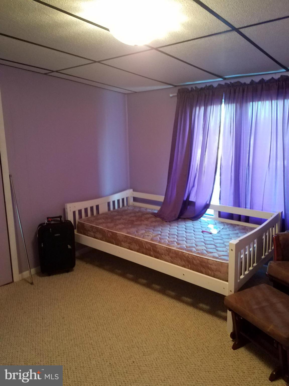 3203 River Drive Road Baltimore, MD 21219 - Photo 11 of 18 a view of bedroom with furniture and a window