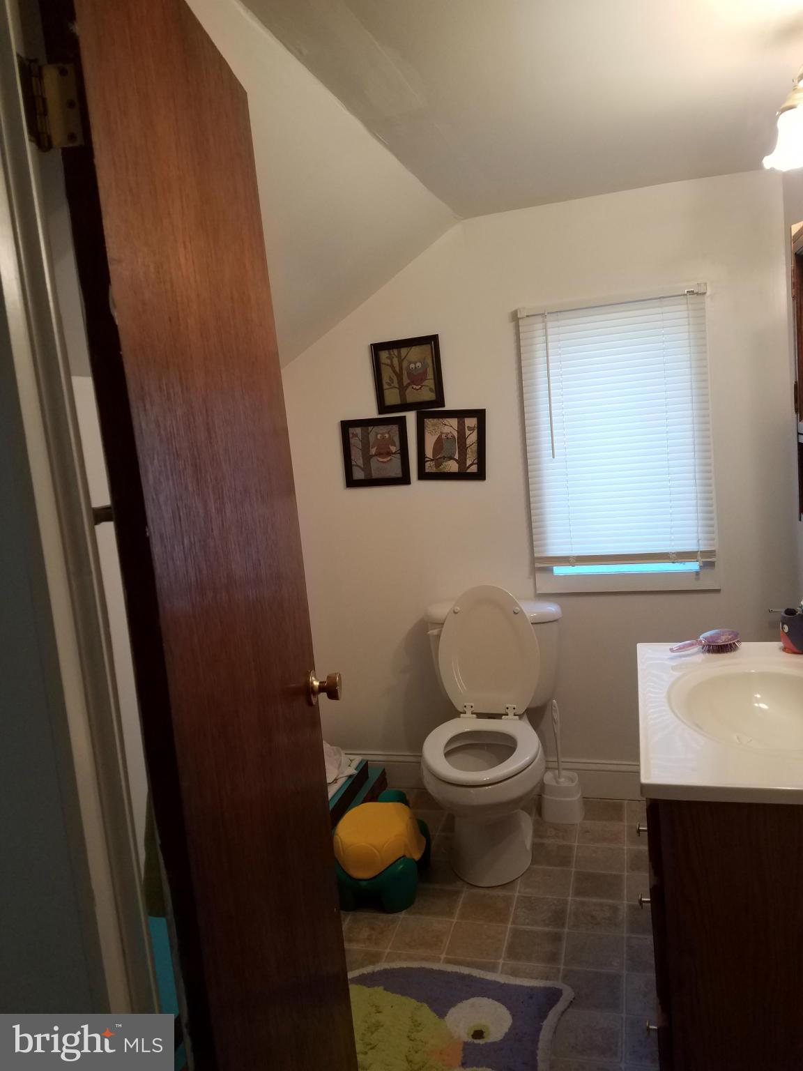 3203 River Drive Road Baltimore, MD 21219 - Photo 13 of 18 a bathroom with a toilet and a sink