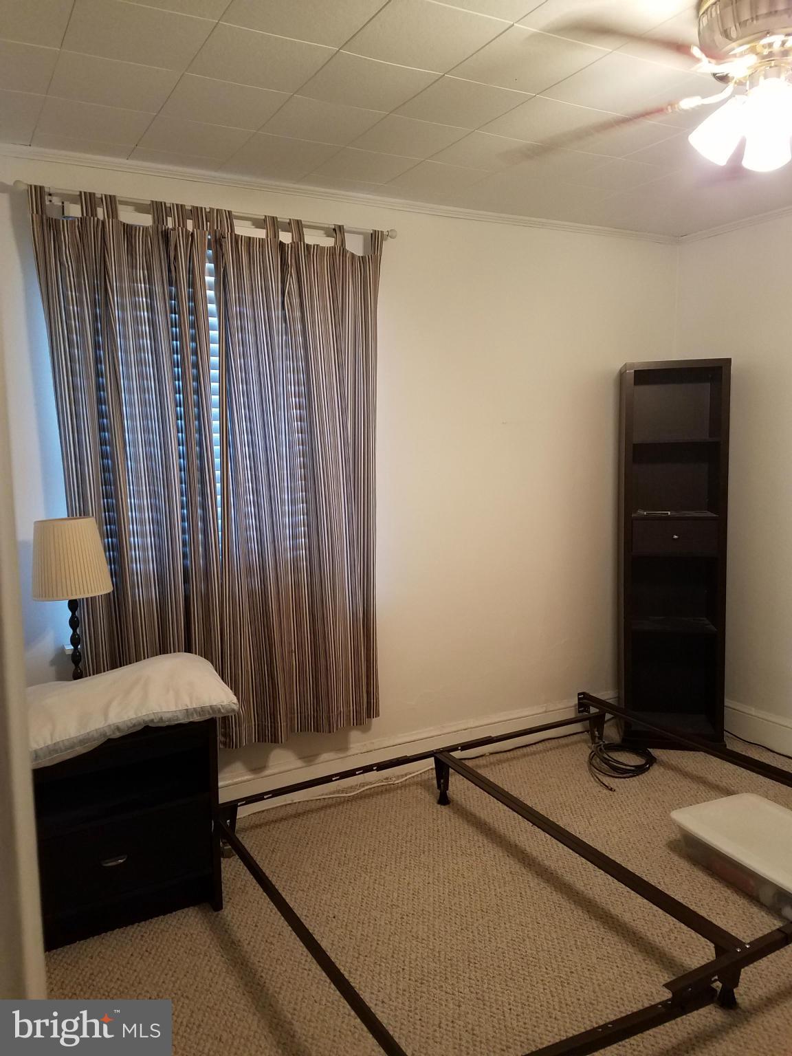 3203 River Drive Road Baltimore, MD 21219 - Photo 10 of 18 a bedroom with a bed and a dresser