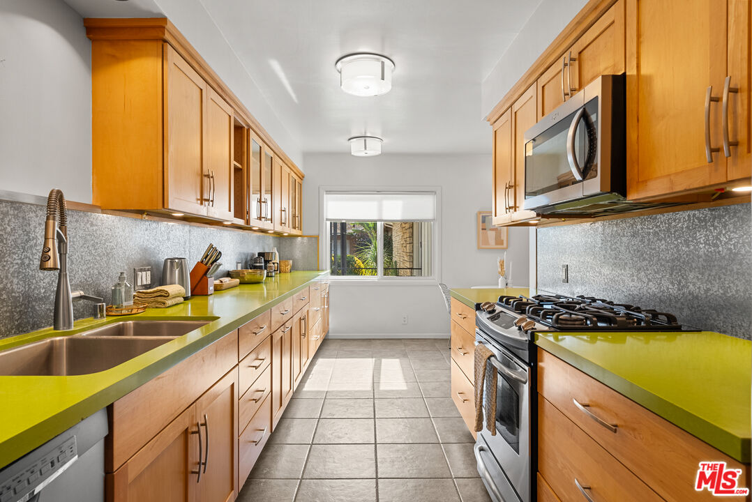 5127 Gaynor Avenue Encino, CA 91436 - Photo 11 of 29 a kitchen with stainless steel appliances granite countertop a sink and a stove