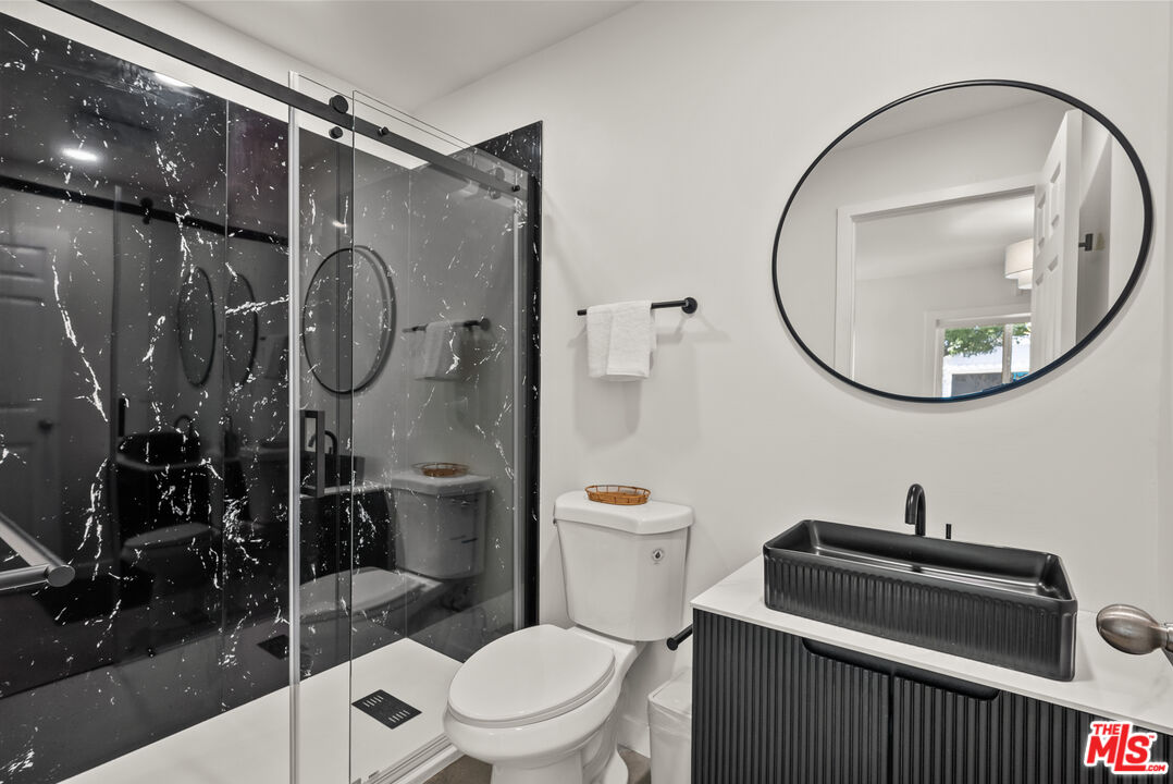 5127 Gaynor Avenue Encino, CA 91436 - Photo 16 of 29 a bathroom with a toilet a sink and shower