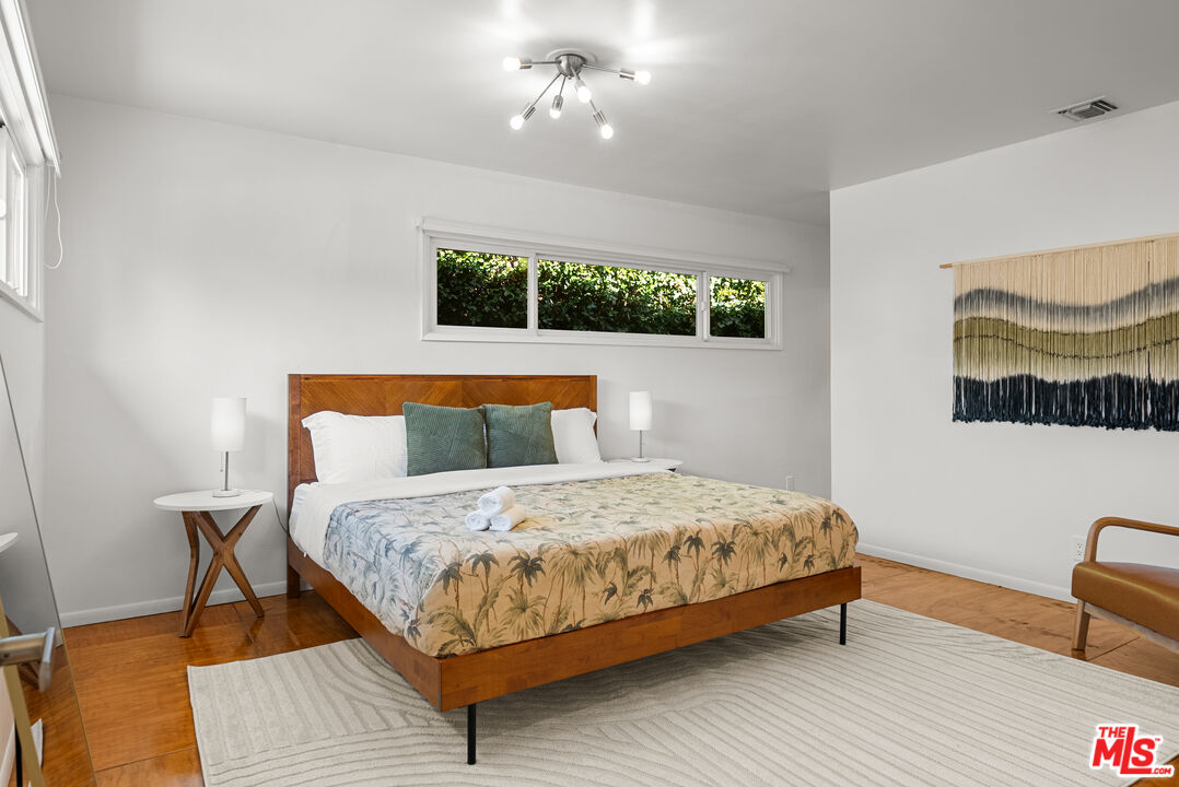 5127 Gaynor Avenue Encino, CA 91436 - Photo 17 of 29 a bedroom with a bed and wooden floor