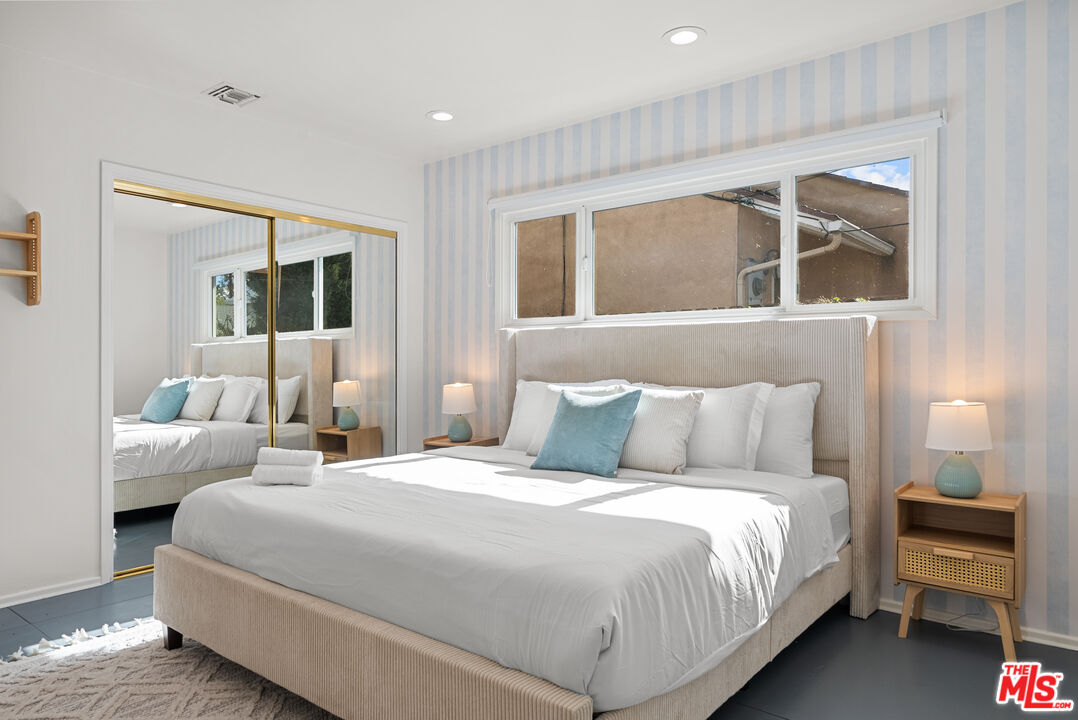 5127 Gaynor Avenue Encino, CA 91436 - Photo 19 of 29 a bedroom with a large bed and a window
