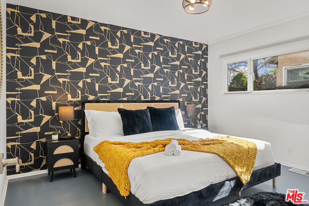 5127 Gaynor Avenue Encino, CA 91436 - Photo 23 of 29 a bed sitting in a bedroom next to a window