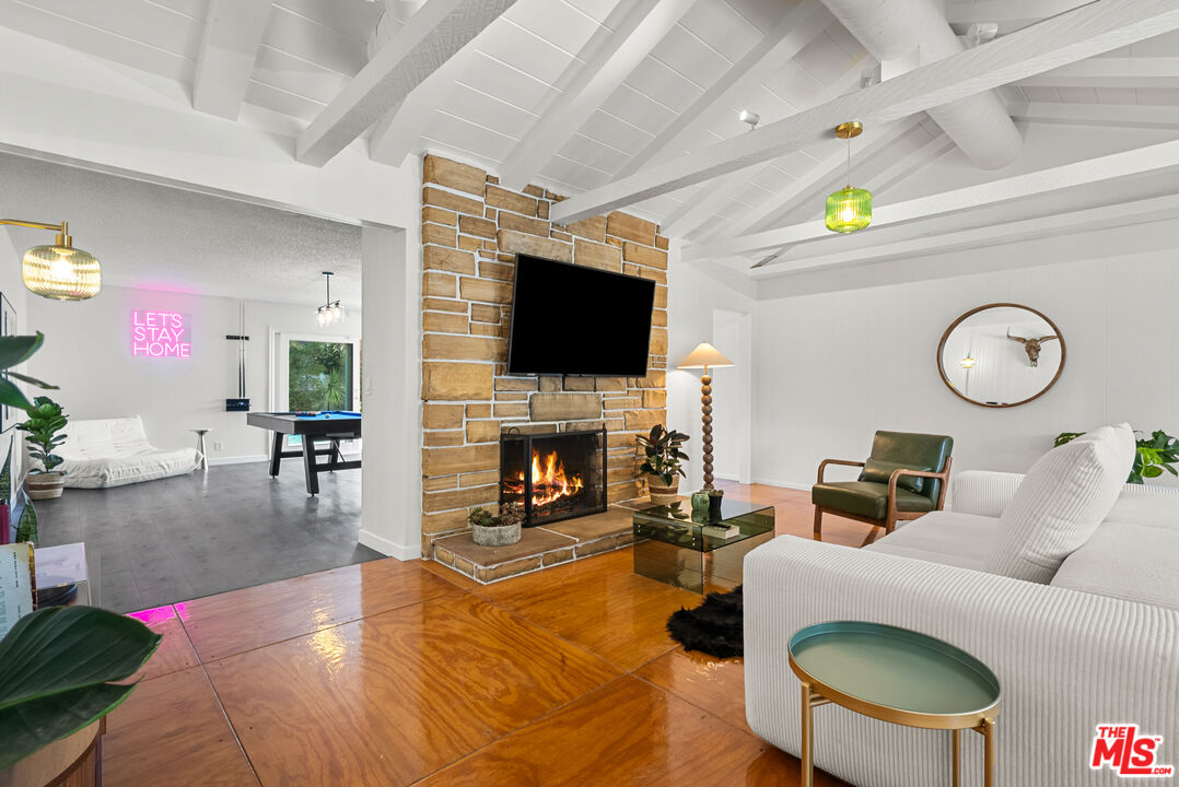 5127 Gaynor Avenue Encino, CA 91436 - Photo 5 of 29 a living room with furniture a fireplace and a flat screen tv