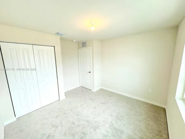 an empty room with a white door