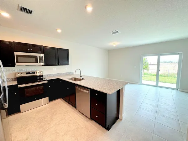 a kitchen with a sink stove and refrigerator