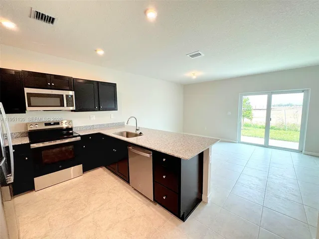 a kitchen with a sink stove and refrigerator