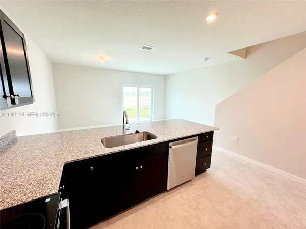 a kitchen with a sink and a refrigerator