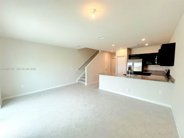 a view of a kitchen with a sink and a microwave