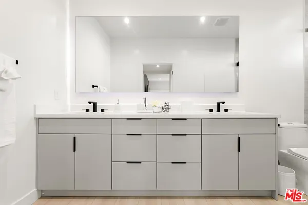 a bathroom with a double vanity sink and mirror