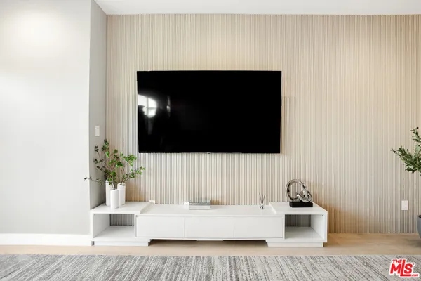 a kitchen with a dining table chairs stainless steel appliances and cabinets