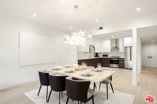 a dining room with a table and chairs