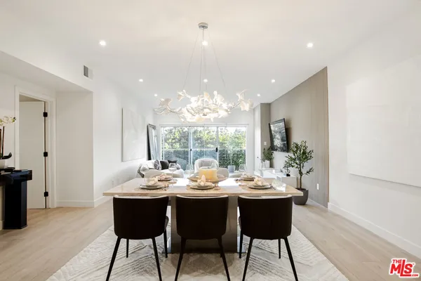 a living room with a table and a mirror