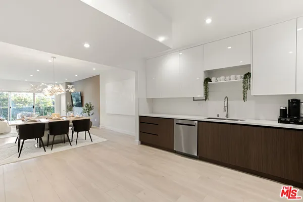 a kitchen with stainless steel appliances granite countertop a refrigerator sink and stove