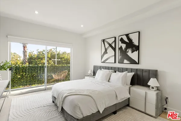 a large white bed in a white room