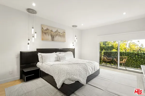 a black and white bed in a small room