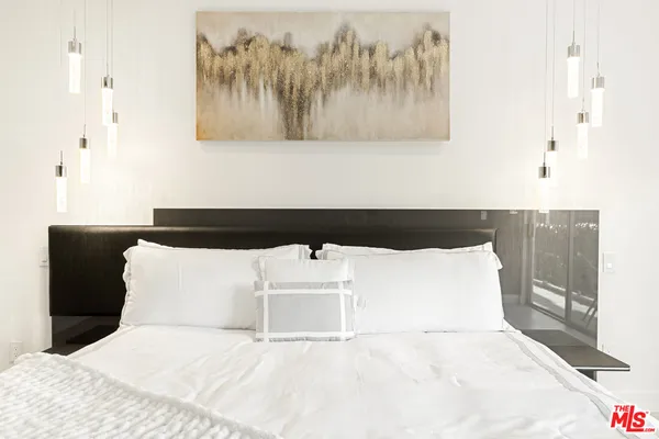 a bedroom with a bed and flat screen tv