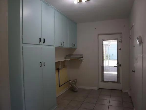 a kitchen with a sink window and refrigerator