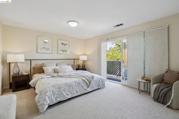 a bedroom with a bed and a couch