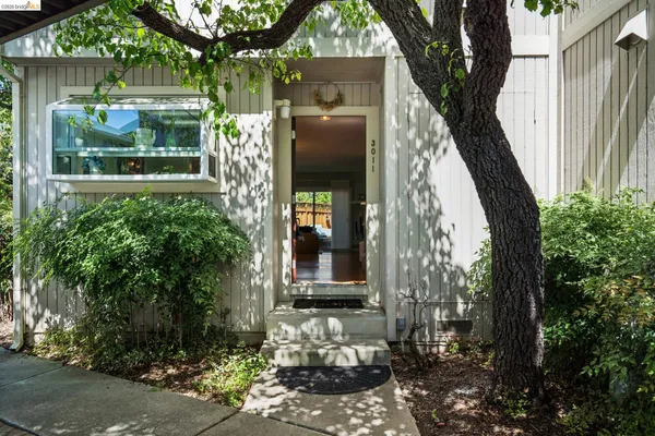 a hallway with a couch and a dining table next to a window
