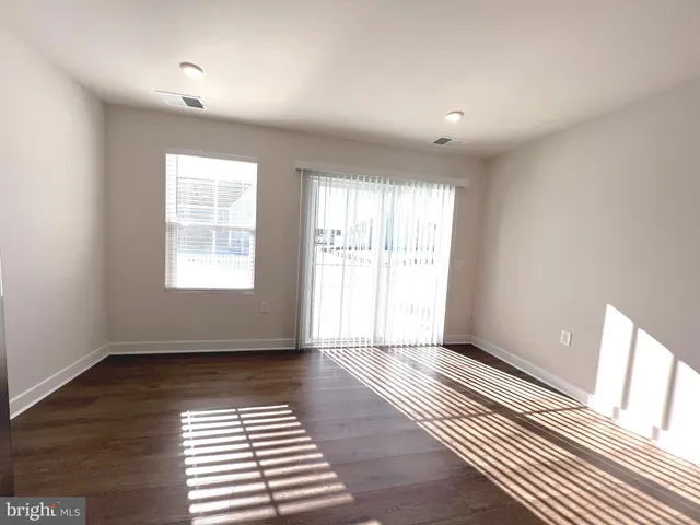 a kitchen with stainless steel appliances kitchen island granite countertop a refrigerator and a sink