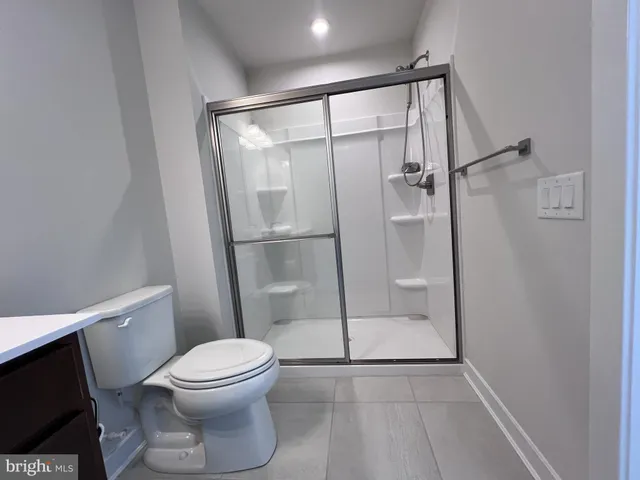 a bathroom with a glass shower door