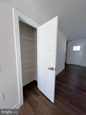 a kitchen with kitchen island granite countertop a sink cabinets and wooden floor