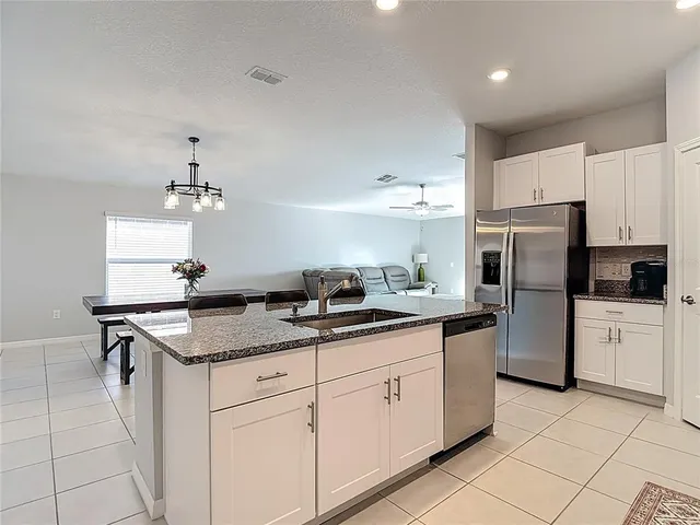 a kitchen with white cabinets sink and white appliances