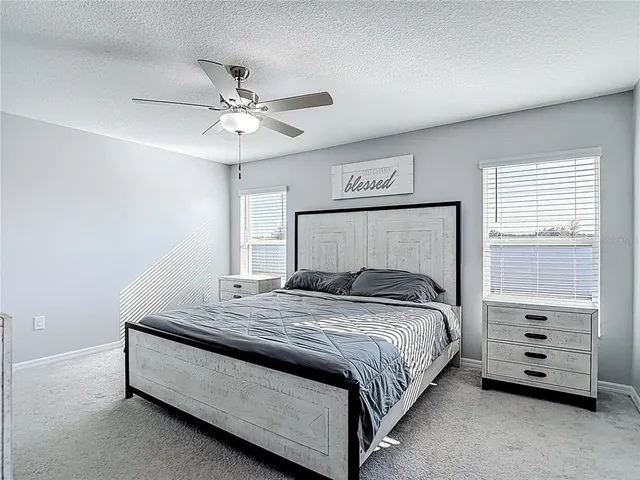 a bedroom with a bed a dresser and a window