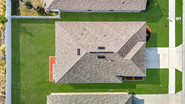 a view of an house with backyard space and balcony