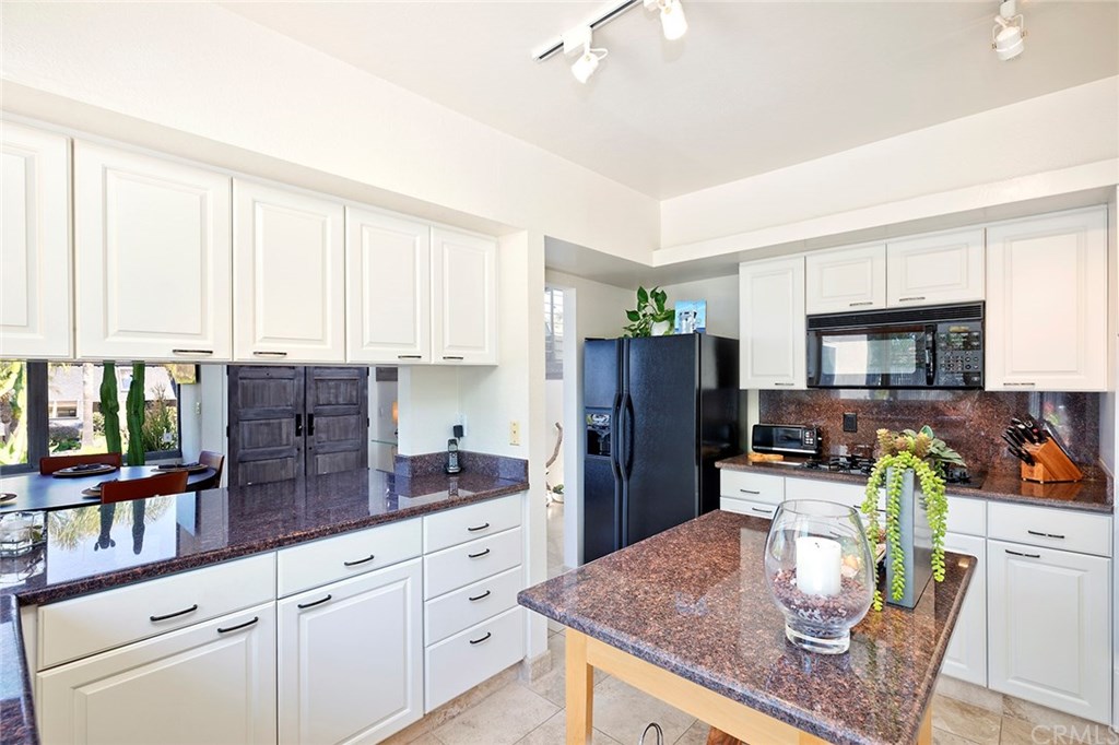 1450 Morningside Drive Laguna Beach, CA 92651 - Photo 19 of 33 Granite counters, island table and pass through to dining provide great workspace