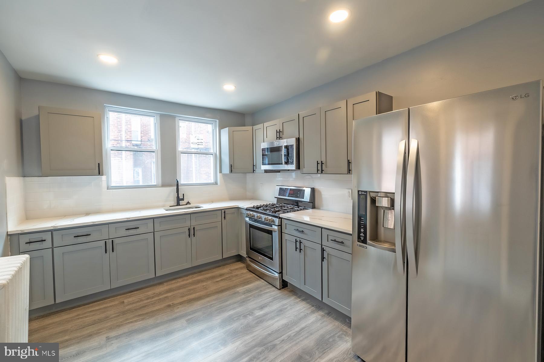 a kitchen with cabinets a sink and stainless steel appliances
